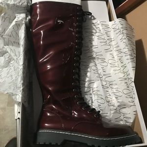 Knee high patent leather boots.